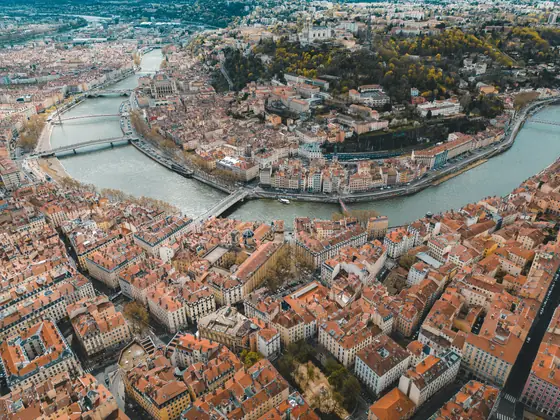 An aerial view of Lyon, France, with the river curving between rows of old buildings