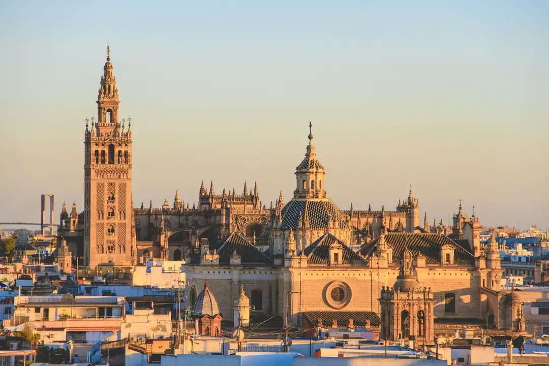 The Giralda tower and Seville Cathedral rising above the rooftops of Sevilla, Spain